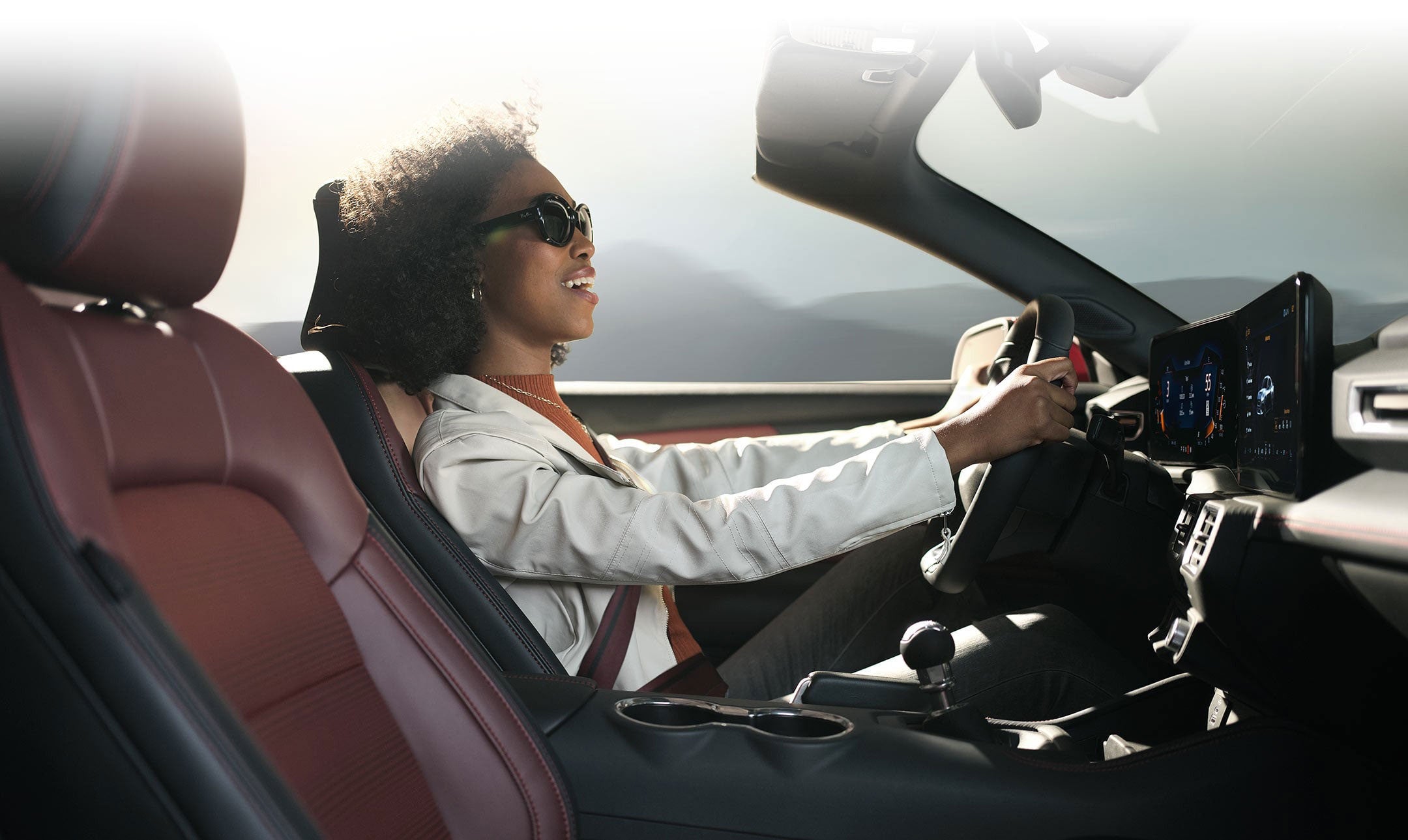 Person sitting in the driver’s seat of a 2024 Ford Mustang® convertible | O'Rourke Motors Inc in Tipton IA